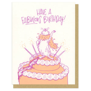 A greeting card and envelope featuring an illustration of a hamster in a feather boa who has climbed to the top of a birthday cake. The text says "Have a fabulous birthday!"