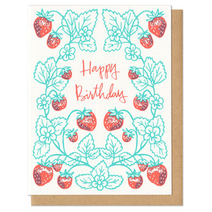 Greeting card and kraft paper envelope. "happy birthday" hand written in red, cheerful script, centered. Surrounded by a whimsical frame of strawberry plants; green and red.