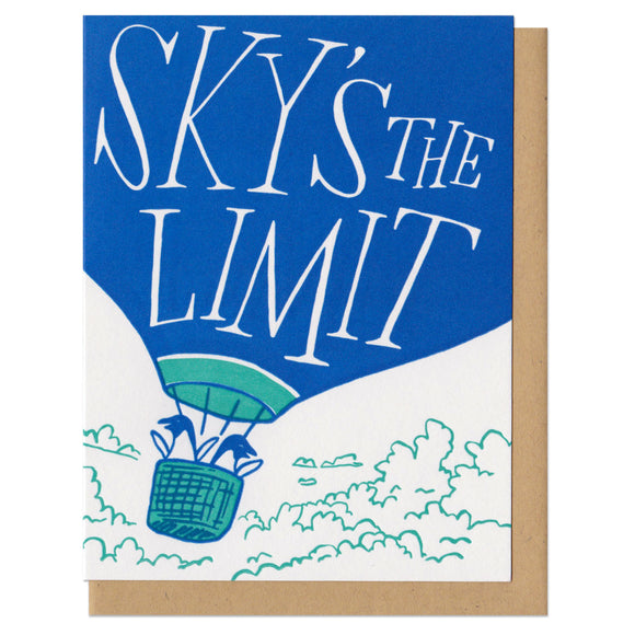 white greeting card featuring an illustration of two penguins riding in a hot air balloon. hand-lettering on the balloon reads 