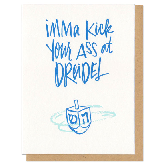 A greeting card and envelope featuring a blue dreidel with hand drawn text about that says 