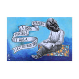 postcard of a blue, grey, and orange illustration of a fellow reading a book with ribbon coming out of his head which reads "reading a book wishing it was a letter from you"