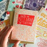 stack of greeting cards featuring one with a flower patter which reads "you're the best mom I've ever had"