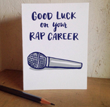 Greeting card and kraft paper envelope. Card reads in handwritten font, "good luck on your rap career." Illustration below of microphone.