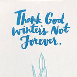 detail of blue printed hand-lettering that reads "thank god winter's not forever"