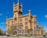 A 5" x 7" art print of the Cranston Street Armory in Providence RI. Text reads, "310 Cranston Street 165,000 square feet built in 1907. A castle for the people." The building is hand drawn in black and white.