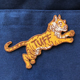 orange tiger patch with "tuff" emroidered on it's middle