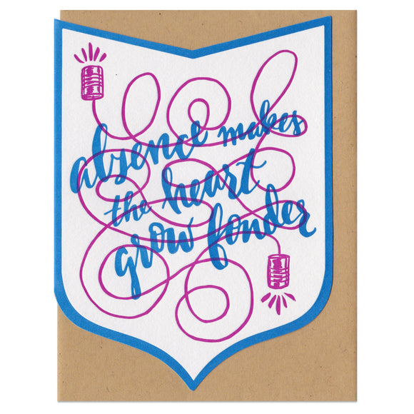 Shield-shaped greeting card with kraft paper envelope. Handwritten text that reads 