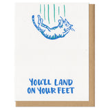 white greeting card featuring an illustrated falling cat which reads "you'll land on your feet"