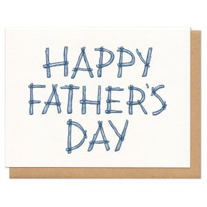 Greeting card and kraft paper envelope. Written in sticks, the card reads, "happy father's day"