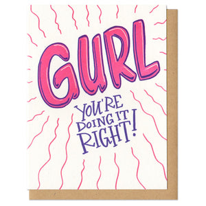 Greeting card and kraft paper envelope. Text in bubble letters reads "GURL" and below it hand written, "You're doing it right!" Bright pink and purple.