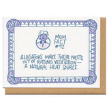 white greeting card with purple and blue illustrated border and a portrait of a short-haired woman. blue hand-lettering in the middle of the card reads "mom fact #92 alligators make their nests out of rotting vegatation - a natural heat source"