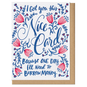 Greeting card with kraft paper envelope. Hand-written text in fancy, script font that reads, "I got you this nice card because one day I'll need to borrow money." Surrounded by navy and pink flowers and leaves.