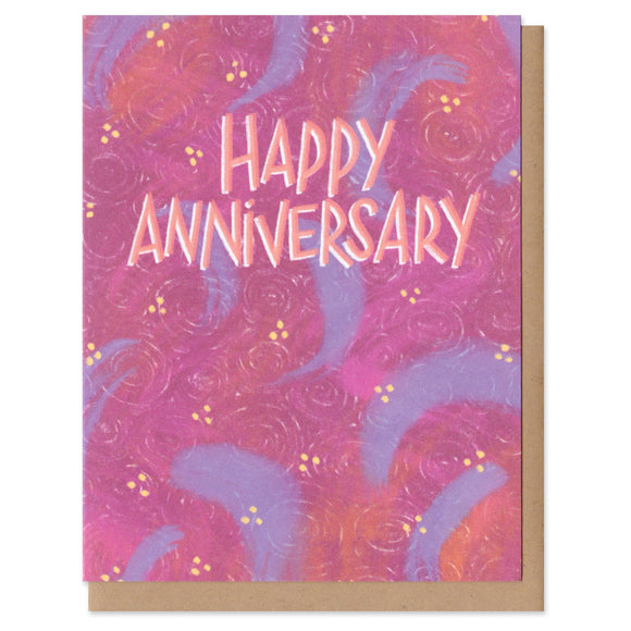 A greeting card and envelope. Happy anniversary is written in all caps in a peachy pink color. The background is magenta and purple abstract swirls. cards, greeting card, anniversary, romance