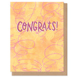 The word "congrats!" handwritten in purple, surrounded by abstract yellow, red, and orange swirls, circles, and blobs