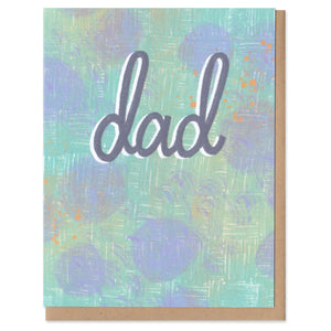 A greeting card and envelope featuring dad written in script in a slate blue. In the background are cornflower blobs on a seafoam cross stitch. Fathers day, dad, greeting card, cards