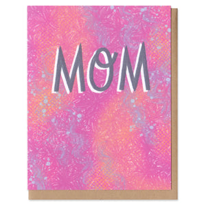 A greeting card and envelope. Capitalized slate blue text reading "MOM" with a textured pink and purple background. mom, mothers day, greeting card, card