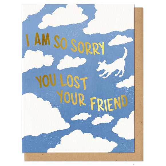 blue greeting card with a white cloud pattern featuring the silhouette of a dog. gold foil stamped lettering reads 