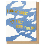 blue greeting card with a white cloud pattern featuring the silhouette of a dog. gold foil stamped lettering reads "i am so sorry you lost your friend"