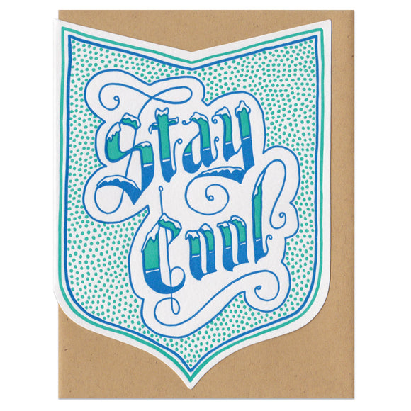 badge-shaped greeting card printed in blue and teal with a dot pattern surrounding handlettering that reads 