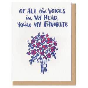 white greeting card featuring a blue and red illustration of a flower bouquet beneath navy hand-lettering that reads "of all the voices in my head, you're my favorite"