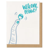 Greeting card and craft envelope that reads "welcome peanut!" in teal, hand-written type in upper right corner. Illustration of elephant trunk shaking rattle.