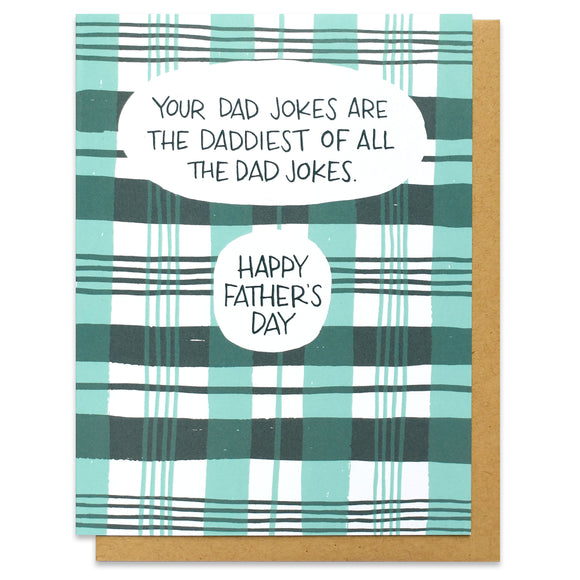 A greeting card and kraft envelope featuring all over printed green and seafoam plaid with a text bubble that says, 