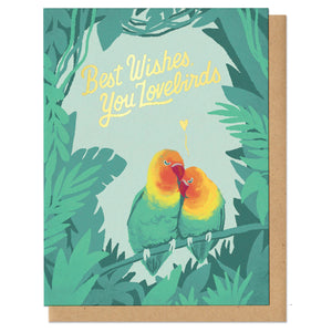 Text in gold foil in handwritten cursive lettering, "Best wishes, you lovebirds." Pair of lovebirds snuggling with gold heart above them, surrounded by lush, tropical greens.
