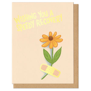 greeting card with gold foil stamping that reads "wishing you a speedy recovery" featuring an illustrated flower and bandaid