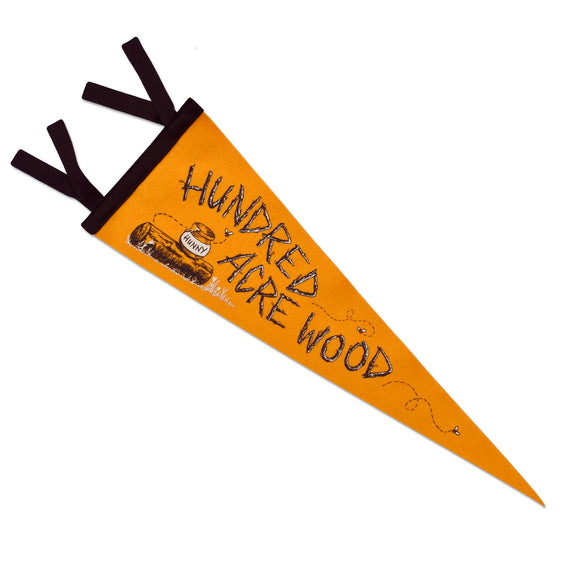 A felted wool camp flag pennant for the Hundred Acre Woods from Winnie the Pooh. This pennant is goldenrod with brown accented logs spelling out Hundred Acre Woods and a pot of hunny sitting on a log with bees buzzing about.