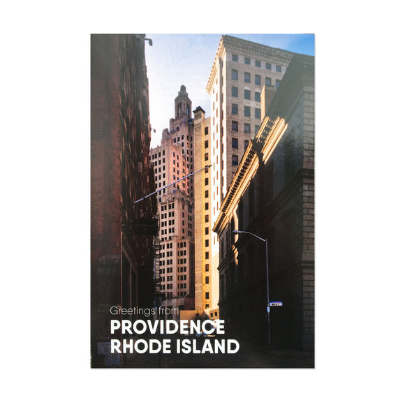 A postcard featuring a view of the industrial trust building in downtown Providence, Rhode Island photographed between the buildings