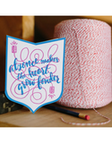 Shield-shaped greeting card with kraft paper envelope. Handwritten text that reads "absence makes the heart grow fonder." Illustration in background of tin cans with string between them.