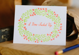 A greeting card and envelope featuring green red florals surrounding text that reads "I don't fucked up".