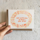 A greeting card and envelope featuring cat and dog motif in yellow and orange with text in the center that says "I love the pets first, but you're a close second."