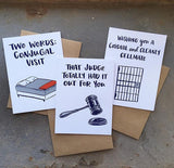 "two words: conjugal visit", "wishing you a cordial and cleanly cellmate", and "that judge totall had it out for you" greeting cards photographed together
